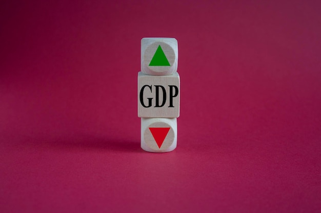 GDP symbol Wooden cubes with the direction of an arrow symbolizing that the GDP are going down or up