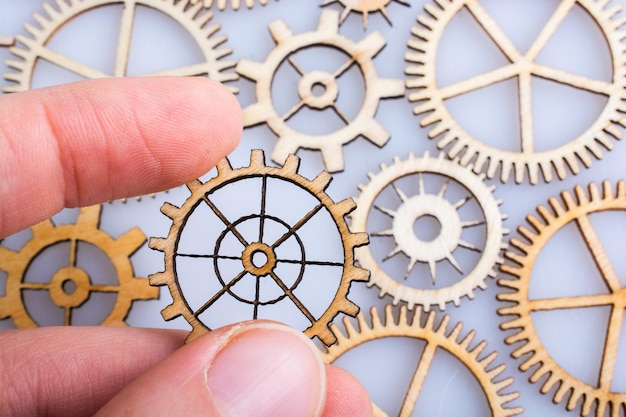 Photo gear wheel in hand on white background as concept of engineering