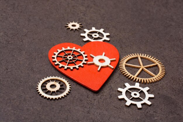 Photo gear wheels on red heart shape valentine concept and promise of love