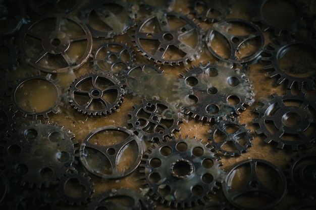 gears and cogwheels on wooden background toned