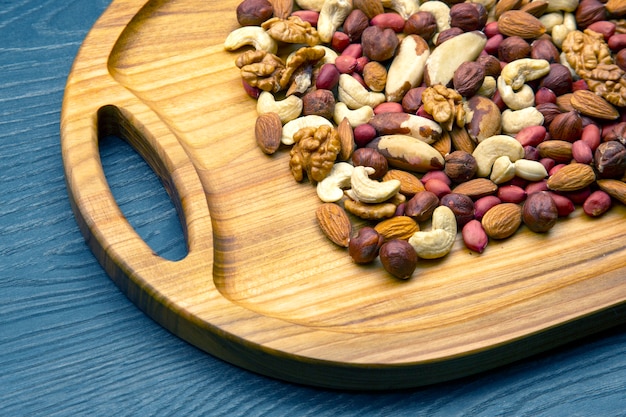 Geassorteerde noten op een houten bord van de keuken. vitamine vegetarisch eten