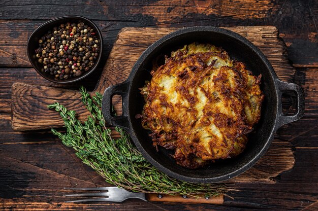 Gebakken Aardappelpannenkoekjes of Fritters met kruiden in een pan