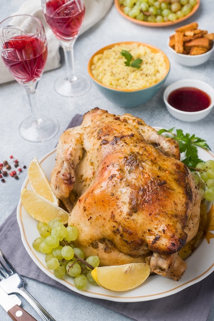 Gebakken kip, aardappelpuree en wijnglazen voor het diner op de feestelijke tafel.