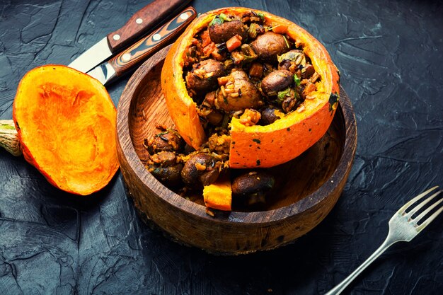 Gebakken pompoen gevuld met champignons en rijst. Traditioneel herfstvoedsel