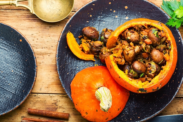 Gebakken pompoen gevuld met champignons en rijst. Traditioneel herfstvoedsel