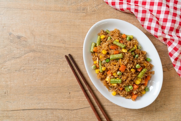 gebakken rijst met groene erwten, wortel en maïs - vegetarische en gezonde voedingsstijl