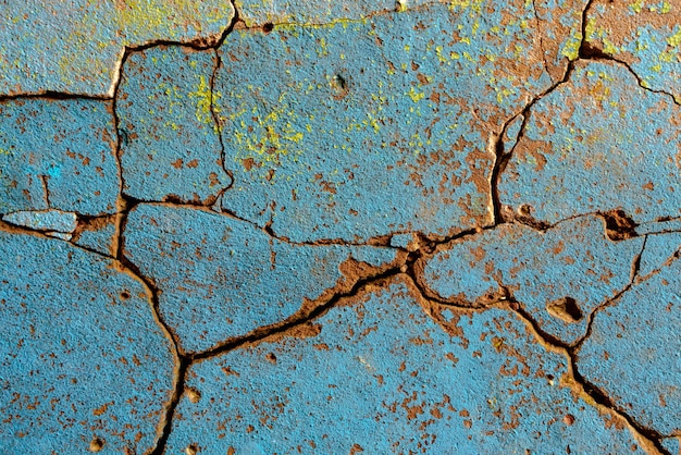 Gebarsten blauw met gele punten getextureerde muur achtergrond