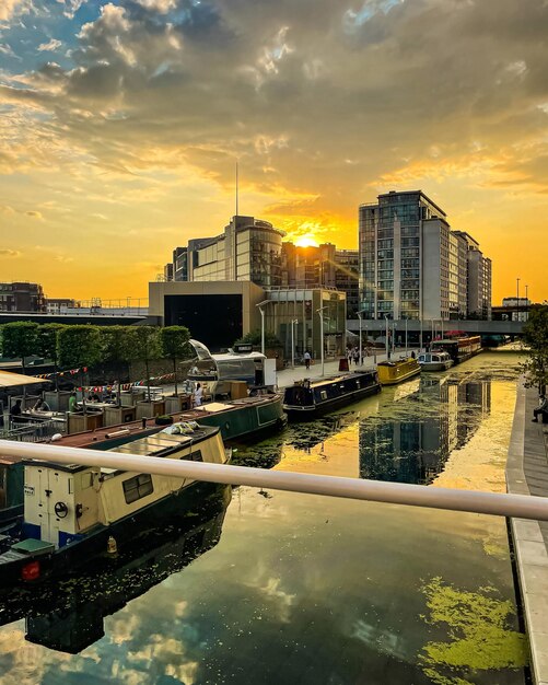 Foto gebouwen bij de rivier tegen de hemel bij zonsondergang