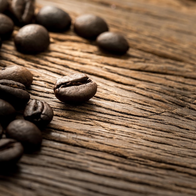 gebrande koffiebonen op grunge houten tafel close-up.