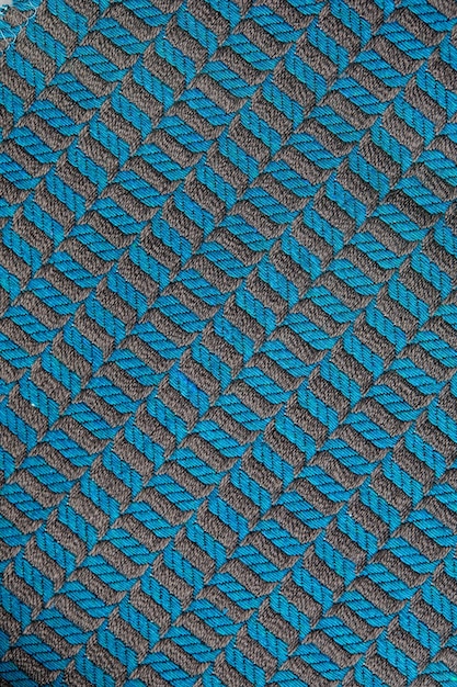 Gebreide textuur Textuur van jacquardstof met grijsblauw geometrisch patroon Gehaakt mozaïekpatroon