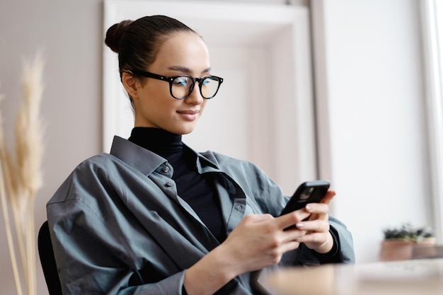 Gebruikt telefoonmanager freelancer Vrouw met een bril op kantoor