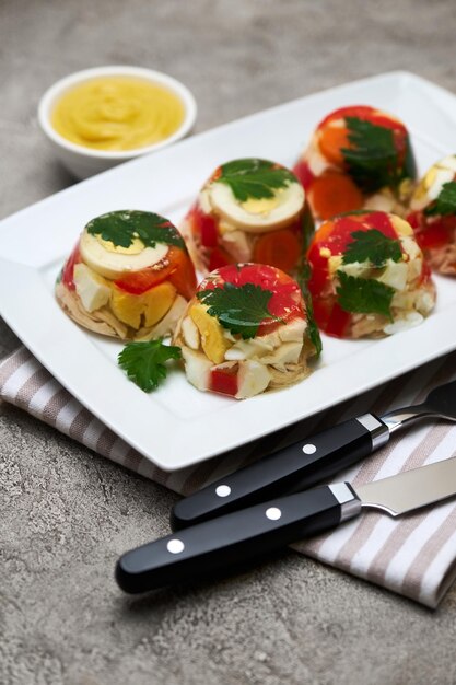 Gedeelte van heerlijke kip aspic op een bord geïsoleerd op betonnen tafel