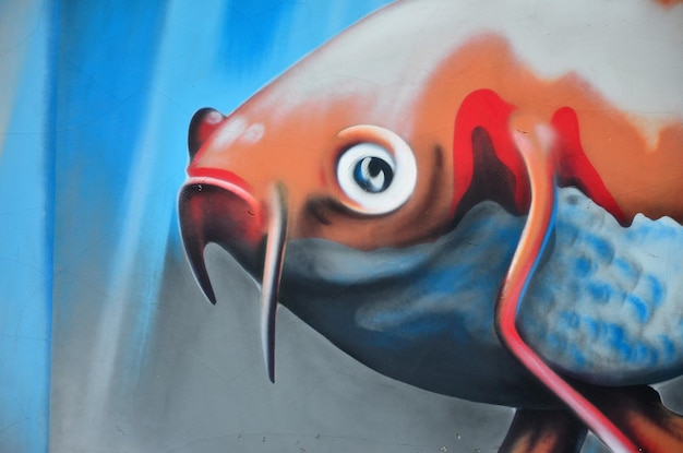 Foto gedetailleerd beeld van kleur graffiti tekening achtergrond street art achtergrond met geschilderde oranje vissen die in de kamer drijven