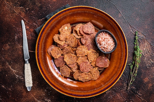 Gedroogd gerookt vlees Jerky van rundvlees en varkensvlees. Donkere achtergrond. Bovenaanzicht.