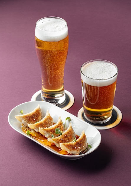 Gedza dumplings with beer on a purple background