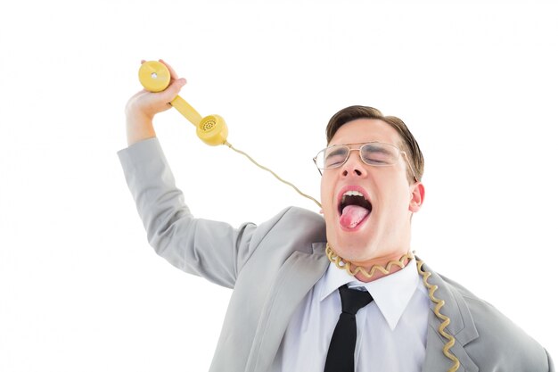 Photo geeky businessman being strangled by phone cord