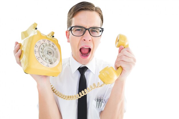 Geeky businessman shouting at retro phone