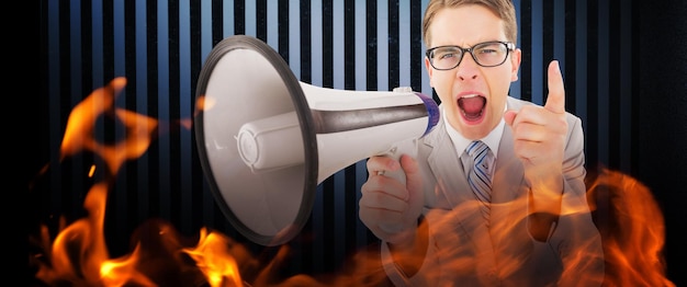 Photo geeky businessman shouting through megaphone against dark grey room
