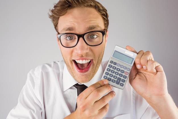 Geeky businessman showing a calculator