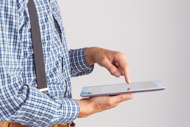 Geeky businessman using his tablet pc