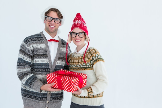 Geeky hipster couple holding present 