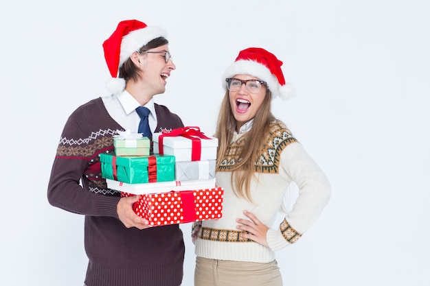 Geeky hipster couple holding presents 