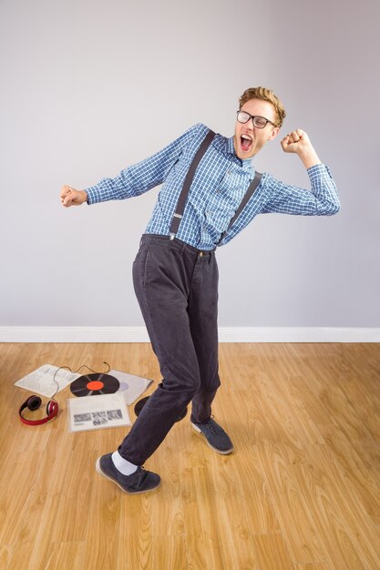 Geeky hipster dancing to vinyl