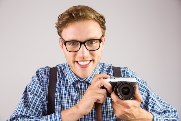 Geeky hipster holding a retro camera