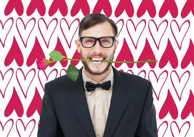 Geeky hipster holding rose between teeth against valentines day pattern