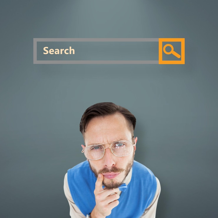 Geeky hipster looking at camera against grey vignette