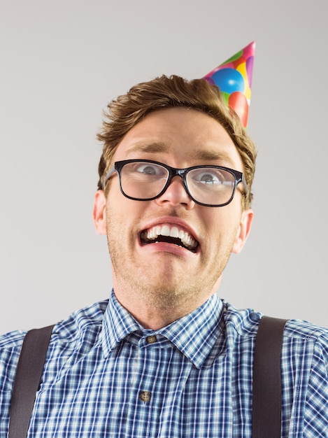 Geeky hipster wearing party hat