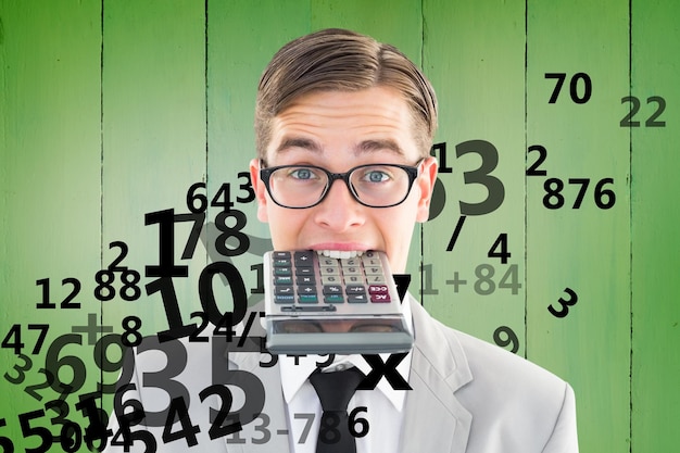 Geeky smiling businessman biting calculator against green vignette