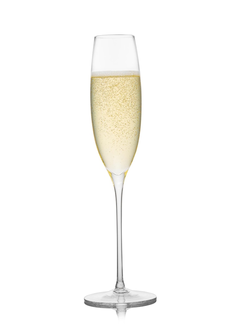 Foto geel gouden champagneglas op witte achtergrond