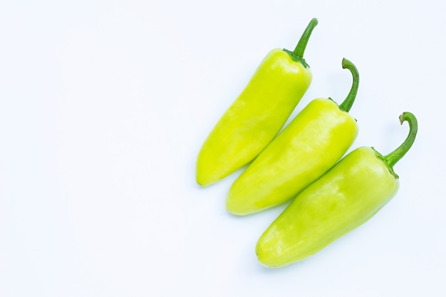 Geen hot peppers on a white background.