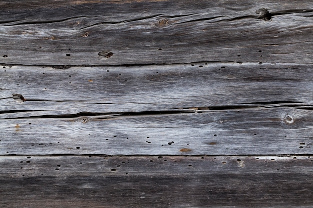 Gefotografeerde close-up van oude planken van een houten schuurmuur