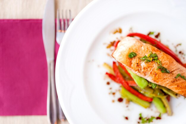 Foto gegrilde gerookte zalmfilet close-up met groenten en saus