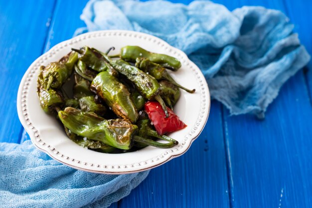 Gegrilde groene paprika op witte plaat op houten