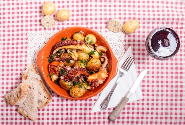 Gegrilde ocotpus met aardappelen, knoflook en salsa.