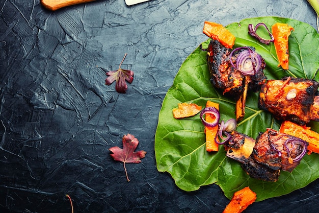 Gegrilde runderribbetjes met pompoen. Geroosterde runderribben op bot