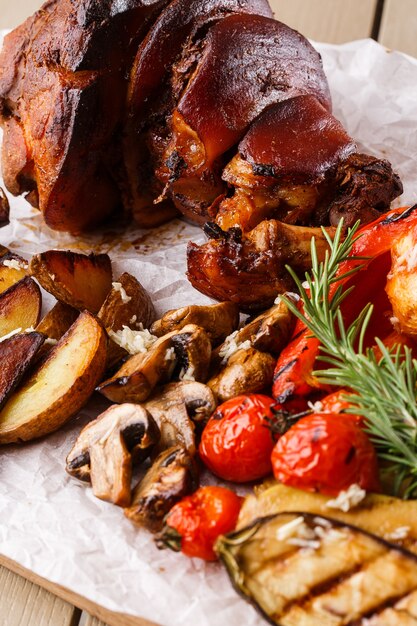 Gegrilde varkensschenkel met gegrilde tomaten, champignons, vagetabel merg, aubergine, rode paprika en gebakken aardappelen