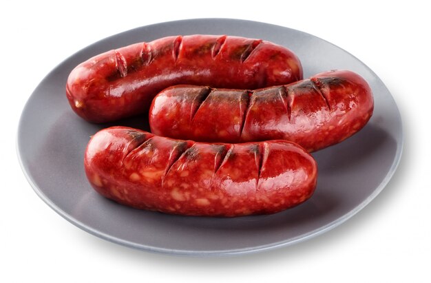 Gegrilde worstjes gekookt op een grill in grijze plaat