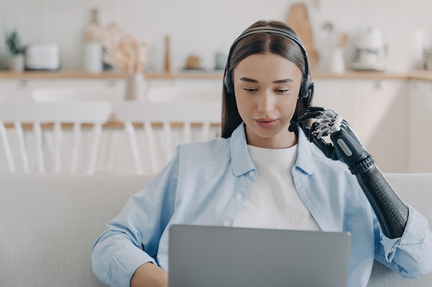 Gehandicapte jonge vrouw in headset heeft online vergadering met computer Werken op afstand