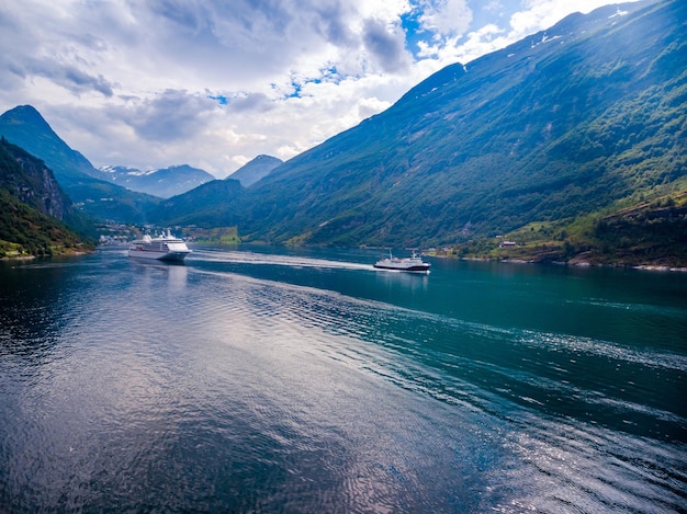 Photo geiranger fjord, beautiful nature norway. it is a 15-kilometre (9.3 mi) long branch off of the sunnylvsfjorden, which is a branch off of the storfjorden aerial photography.