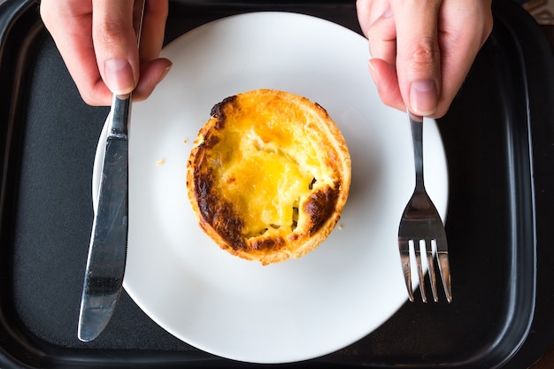 Foto geïsoleerde varkenshaas quiche met iemand hold vork en mes