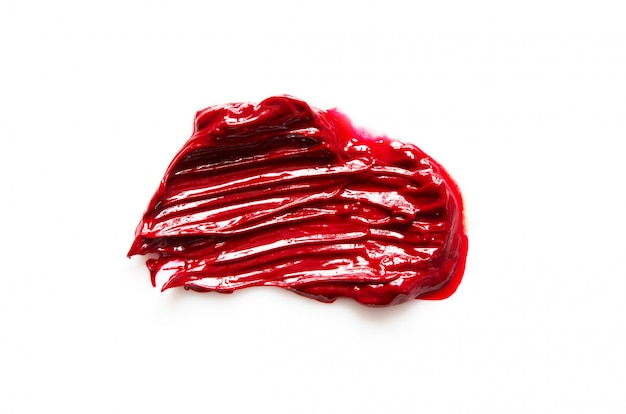 Geïsoleerde vlek en textuur van rode lippenstift of olieverf.