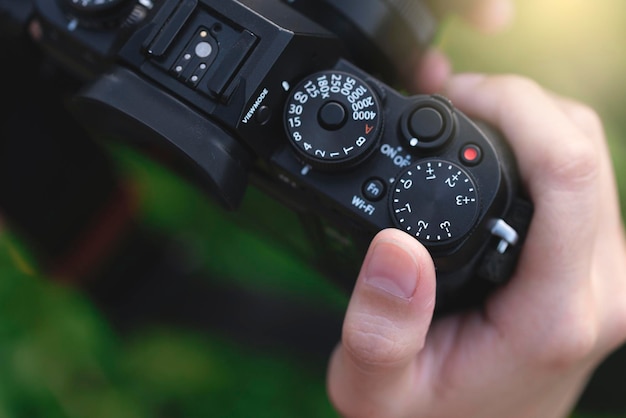 Foto gekapte hand van de persoon die de camera vasthoudt