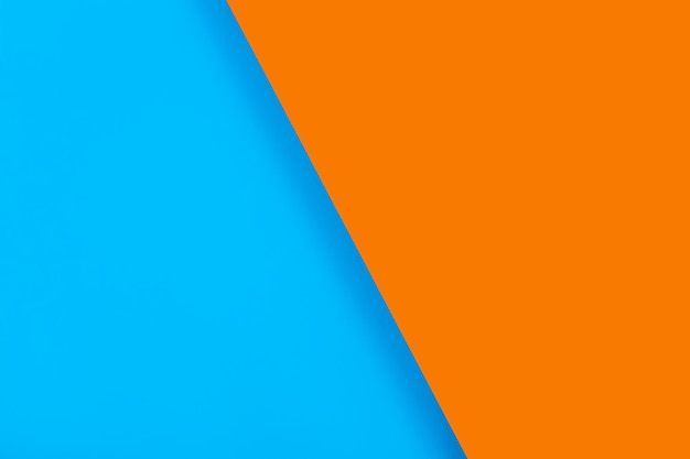 Gekleurd papier achtergrond felle kleur blauw en oranje diagonaal met een schaduw Voor ontwerptekst