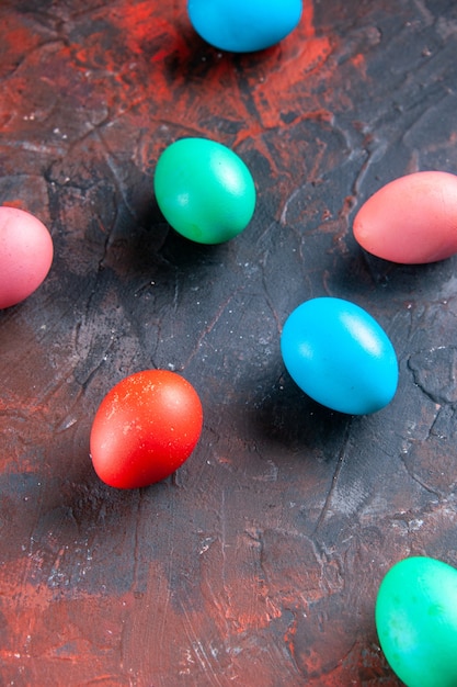 Gekleurde eieren gelegd op donkere kleuren verontruste achtergrond met vrije ruimte