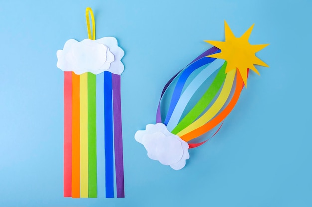 Gekleurde regenboog en witte wolken van doe-het-zelf papier en kindercreativiteit Knutselen voor kinderen tot Internationale werelddag van de vrede