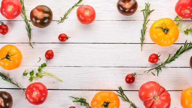 Gekleurde tomaten op een witte houten achtergrond bovenaanzicht ruimte kopiëren